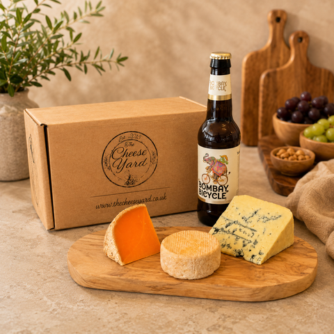 The Cheese Yard beer and cheese gift box with Bombay Bicycle beer and three artisan cheeses on a wooden board